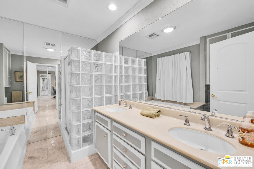 10 International Boulevard Rancho Mirage, CA 92270 - Photo 21 of 36 a bathroom with a double vanity sink and a mirror