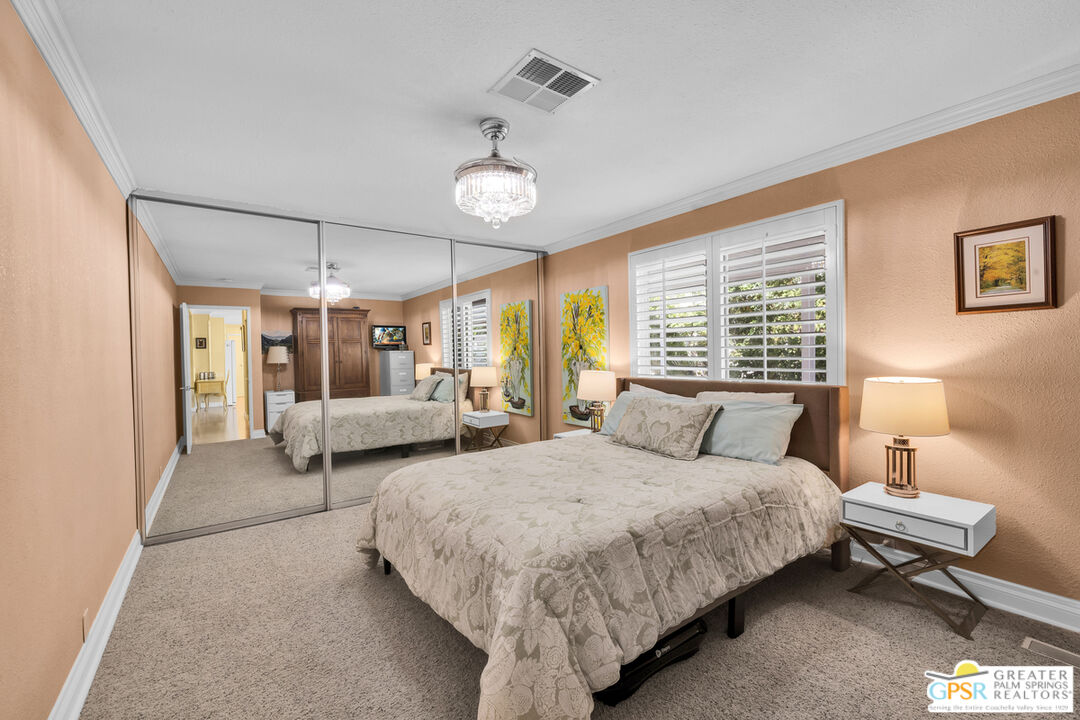 10 International Boulevard Rancho Mirage, CA 92270 - Photo 22 of 36 a bedroom with bed and a large window