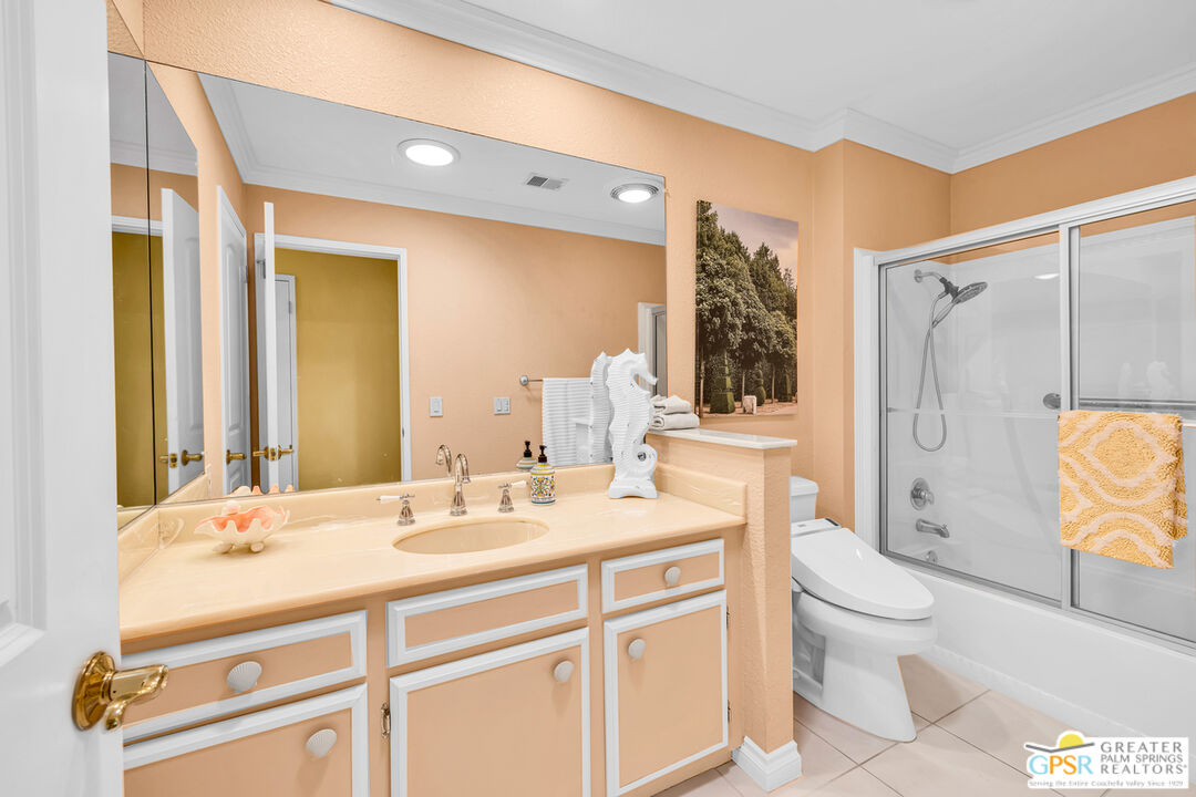 10 International Boulevard Rancho Mirage, CA 92270 - Photo 23 of 36 a bathroom with a granite countertop sink toilet and shower