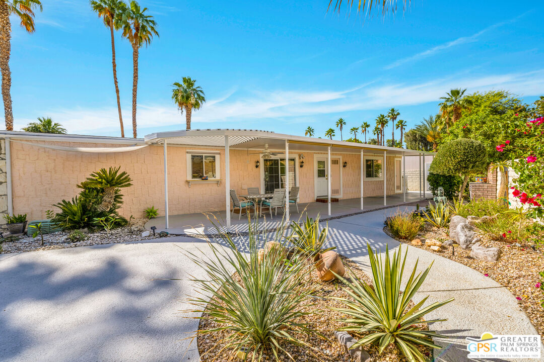10 International Boulevard Rancho Mirage, CA 92270 - Photo 25 of 36 front view of a house with a yard