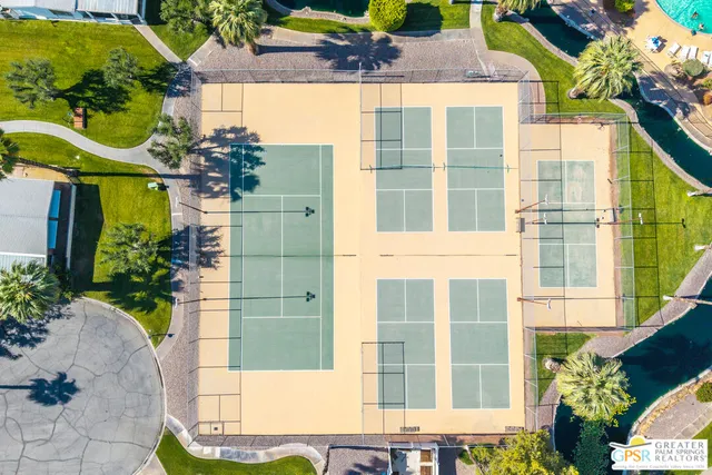 front view of a brick house with a yard