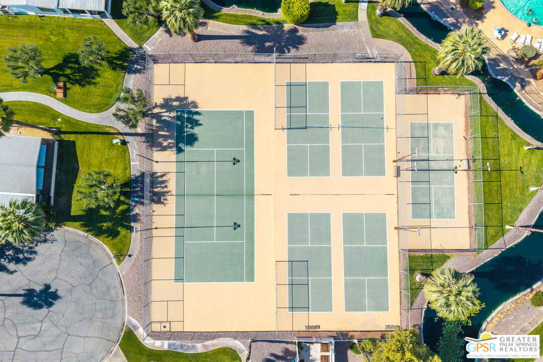 10 International Boulevard Rancho Mirage, CA 92270 - Photo 35 of 36 front view of a brick house with a yard