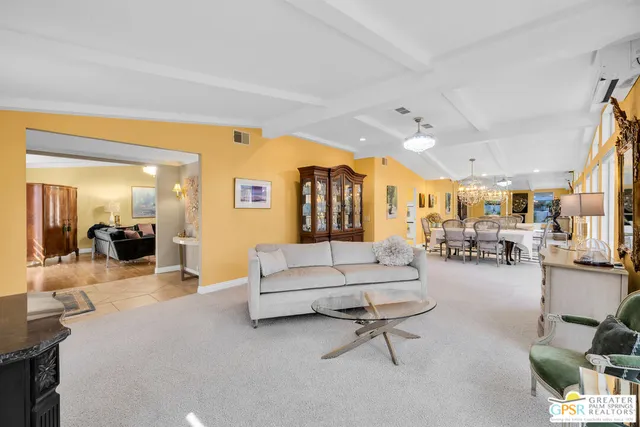 a living room with furniture and a large mirror