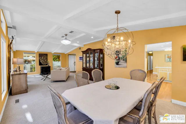 a view of a dining room with furniture and chandelier