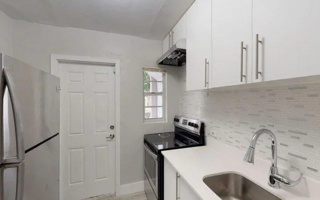 a kitchen with stainless steel appliances a refrigerator and a sink