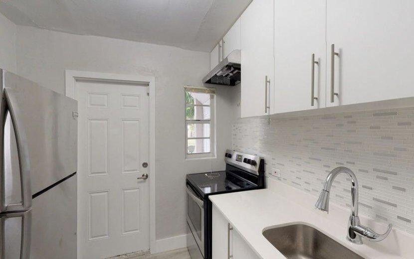 2722 Poinsettia Avenue, Unit 4 West Palm Beach, FL 33407 - Photo 2 of 6 a kitchen with stainless steel appliances a refrigerator and a sink