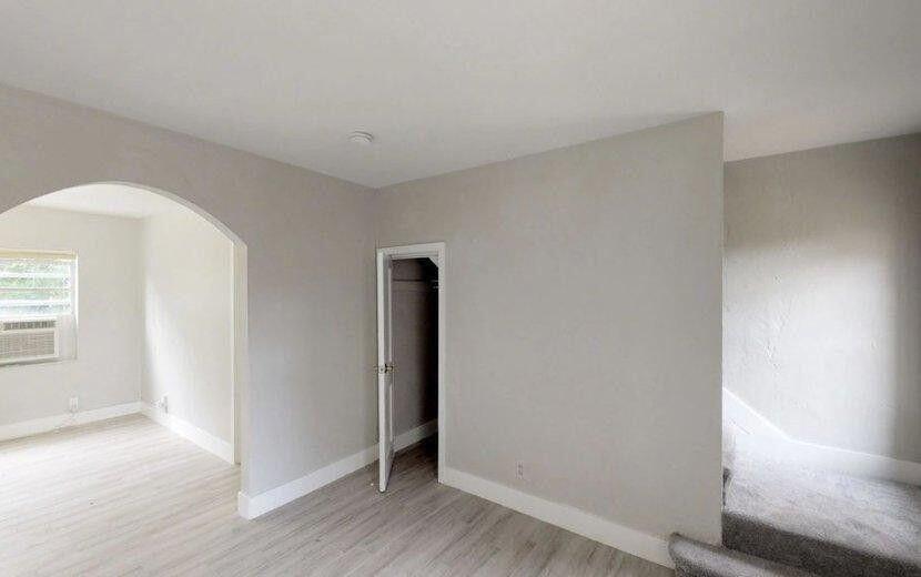 2722 Poinsettia Avenue, Unit 4 West Palm Beach, FL 33407 - Photo 4 of 6 an empty room with wooden floor and windows