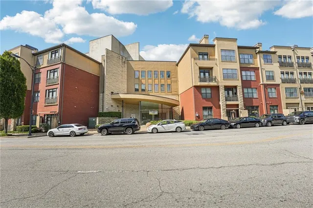 a kitchen with stainless steel appliances granite countertop a sink a stove and a wooden floors