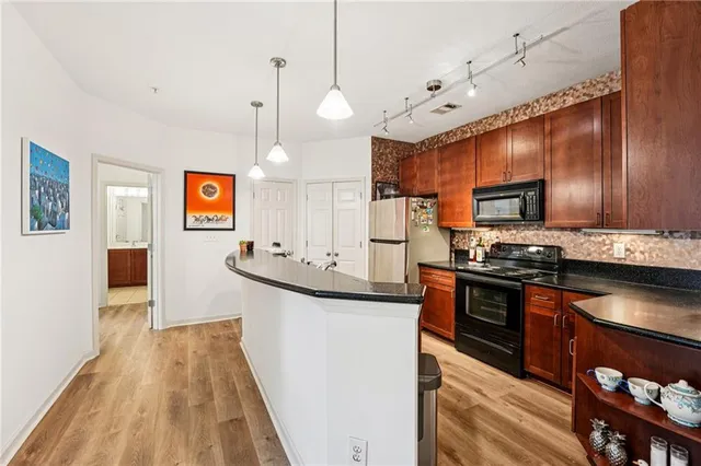 a living room with furniture and kitchen view