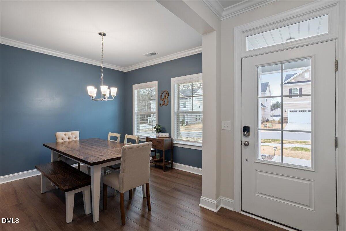 4038 Front Runner Drive Durham, NC 27703 - Photo 10 of 47 a view of a dining room with furniture window and wooden floor