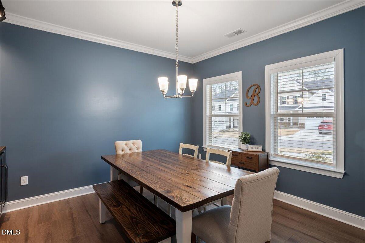 4038 Front Runner Drive Durham, NC 27703 - Photo 11 of 47 a view of a dining room with furniture window and wooden floor