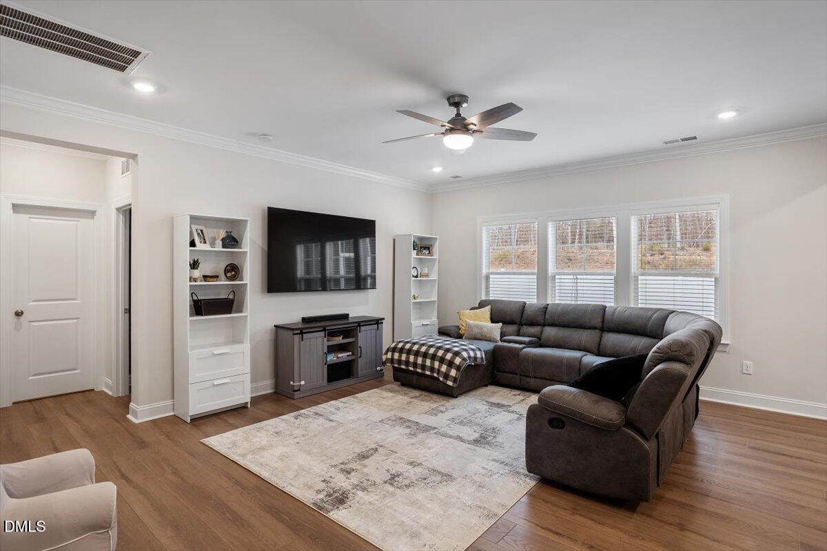 4038 Front Runner Drive Durham, NC 27703 - Photo 13 of 47 a living room with furniture a flat screen tv and a rug