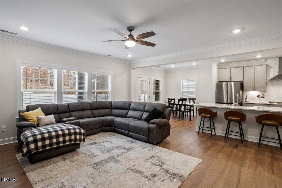 4038 Front Runner Drive Durham, NC 27703 - Photo 15 of 47 a living room with furniture kitchen view and a wooden floor