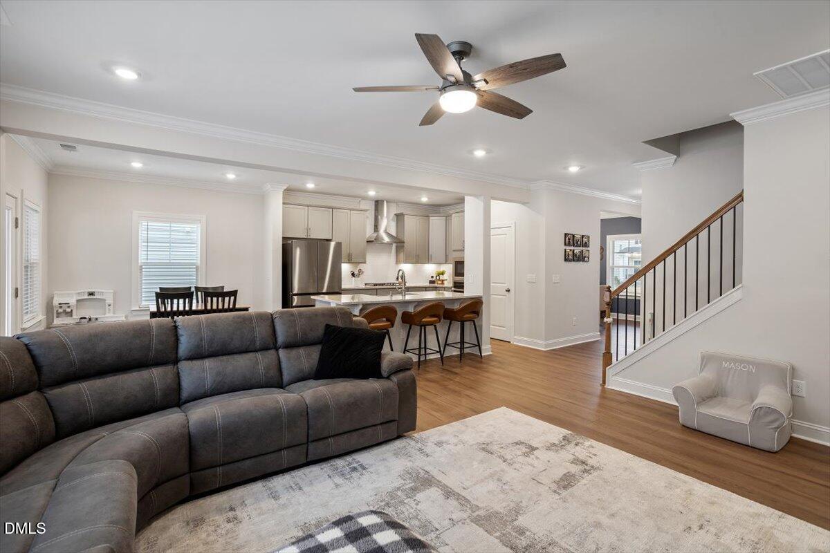 4038 Front Runner Drive Durham, NC 27703 - Photo 16 of 47 a living room with furniture kitchen view and a chandelier