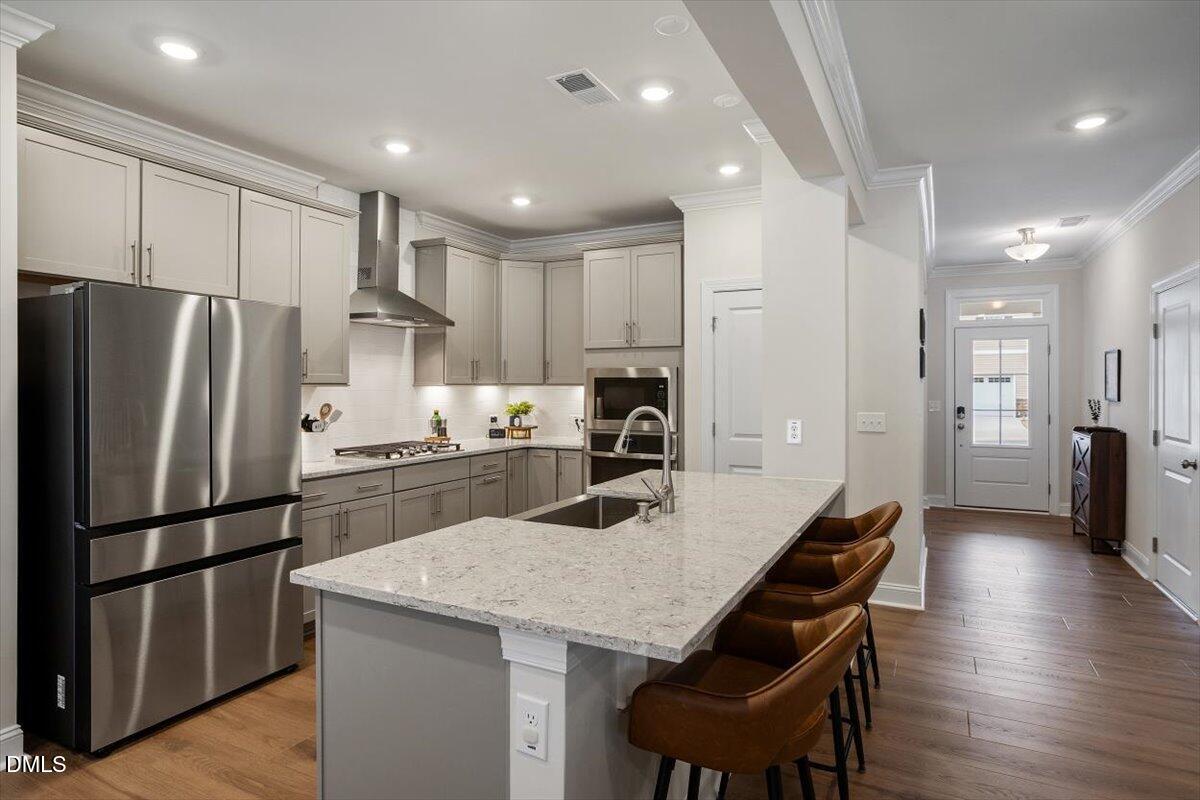 4038 Front Runner Drive Durham, NC 27703 - Photo 21 of 47 a kitchen with refrigerator a sink and chairs