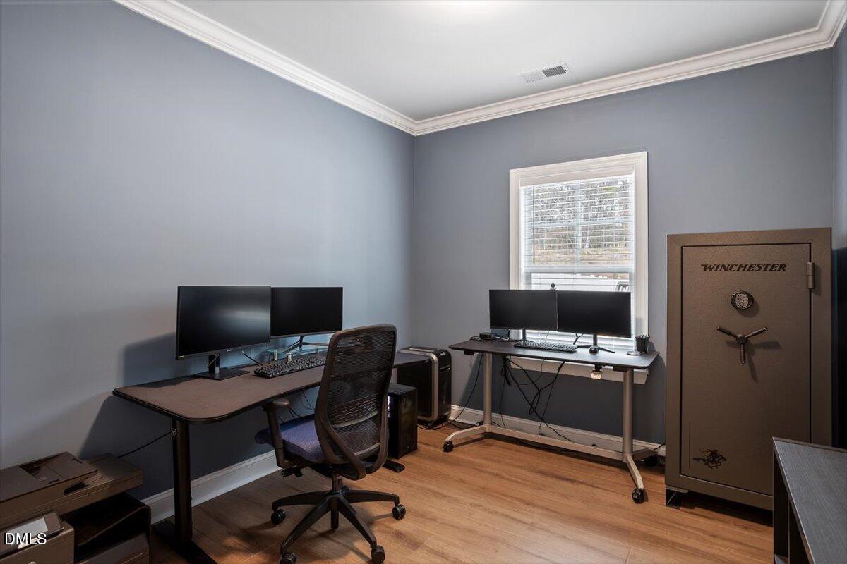 4038 Front Runner Drive Durham, NC 27703 - Photo 23 of 47 a view of a workspace with furniture and a window