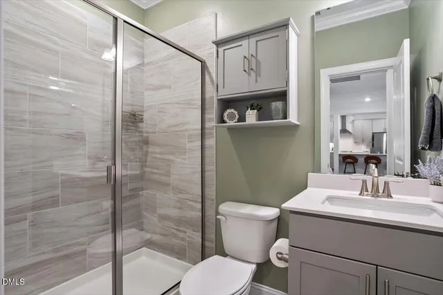 a bathroom with a toilet sink and shower