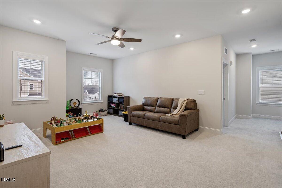 4038 Front Runner Drive Durham, NC 27703 - Photo 26 of 47 a living room with furniture and a chandelier