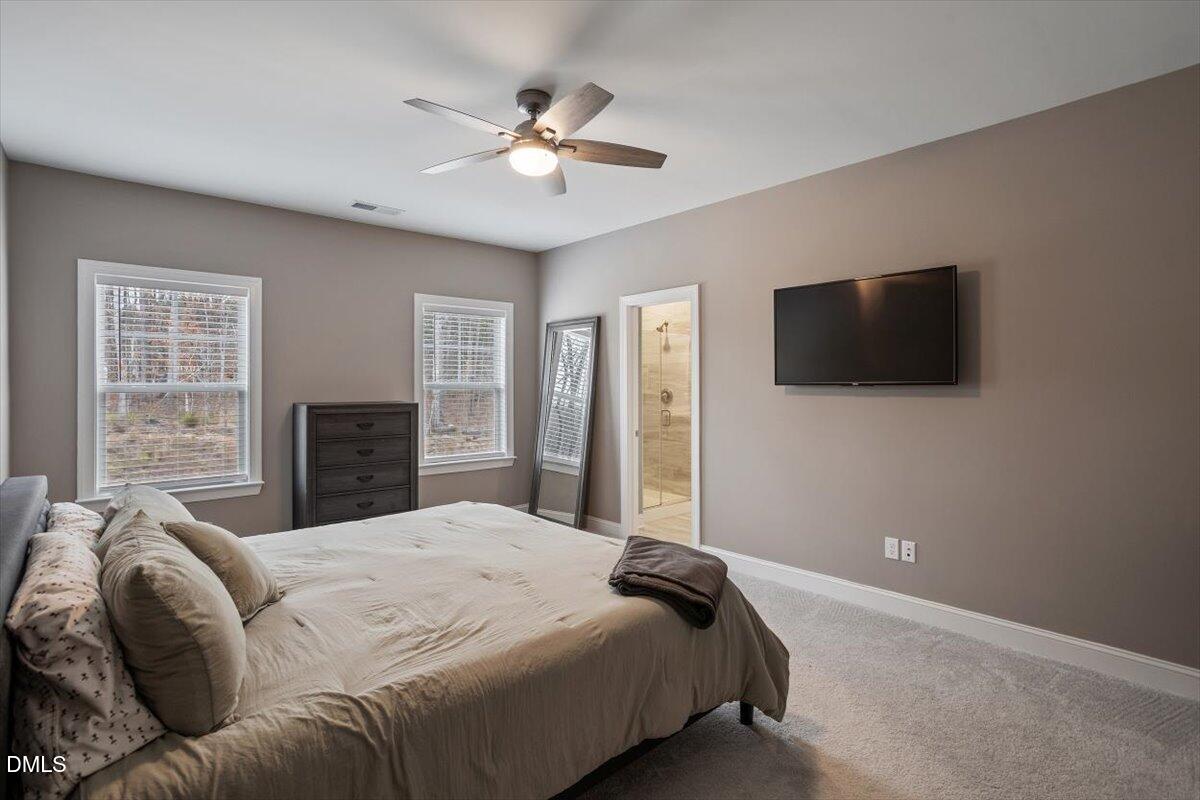 4038 Front Runner Drive Durham, NC 27703 - Photo 27 of 47 a bedroom with a bed and a flat screen tv