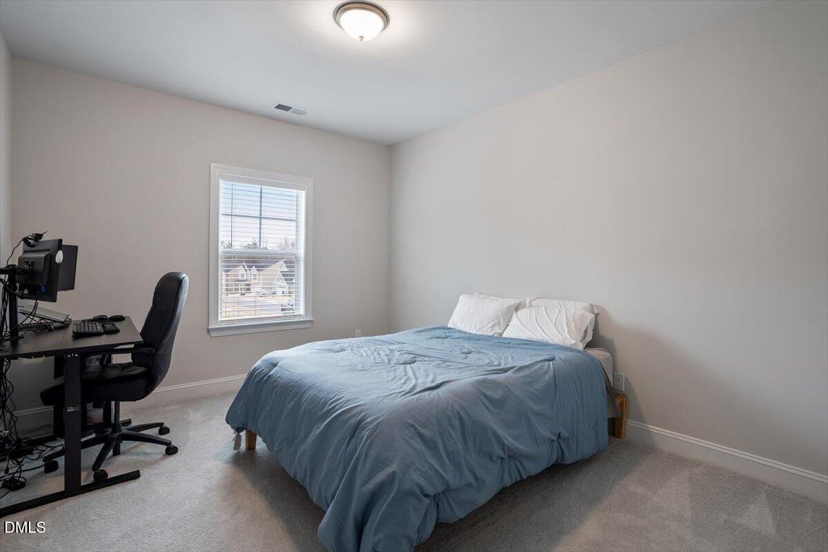4038 Front Runner Drive Durham, NC 27703 - Photo 31 of 47 a bedroom with a bed and a desk