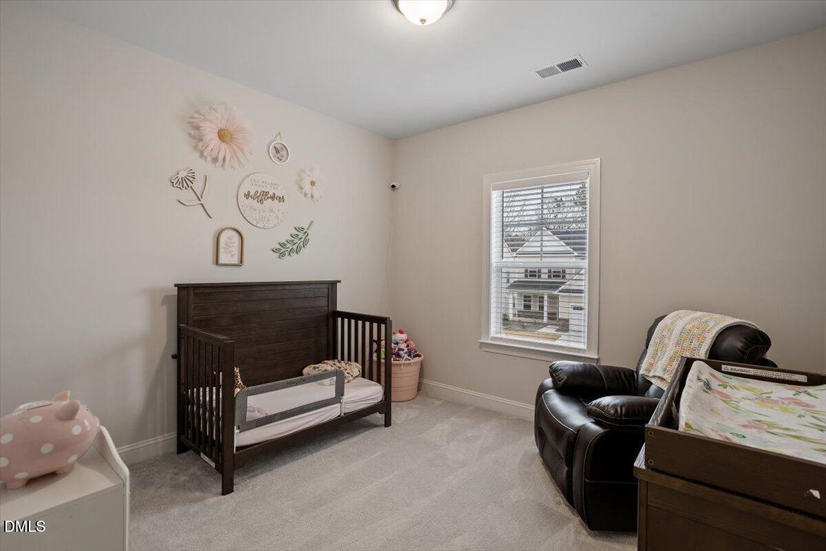 4038 Front Runner Drive Durham, NC 27703 - Photo 32 of 47 a bedroom with a bed and a window