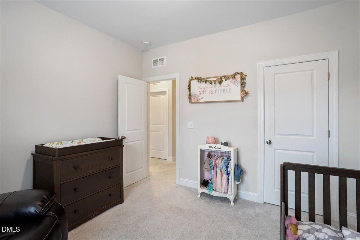 4038 Front Runner Drive Durham, NC 27703 - Photo 33 of 47 a room with a baby crib and a dresser