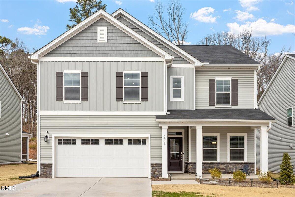 4038 Front Runner Drive Durham, NC 27703 - Photo 38 of 47 a view of a white house with large windows