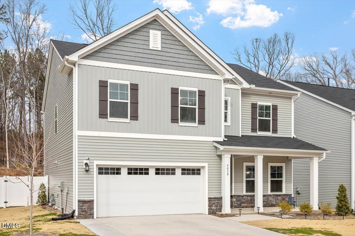4038 Front Runner Drive Durham, NC 27703 - Photo 39 of 47 a view of a white house with large windows