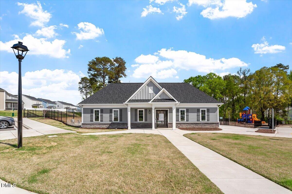 4038 Front Runner Drive Durham, NC 27703 - Photo 43 of 47 a house view with swimming pool and trees in the background