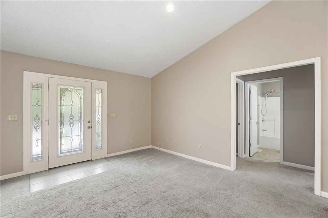1208 Jarva Lane Springboro, OH 45066 - Photo 12 of 75 This bright living space features a vaulted ceiling, providing an airy atmosphere upon entry.