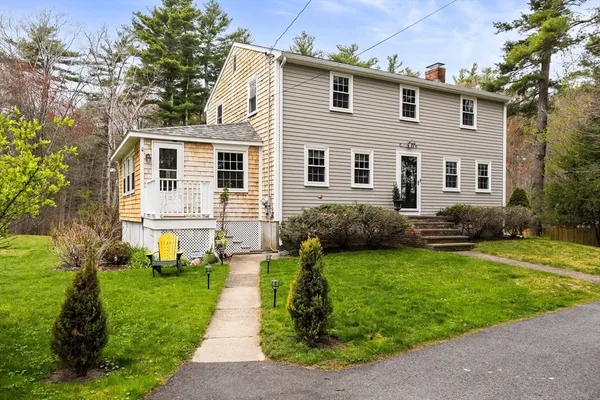 a front view of a house with a garden