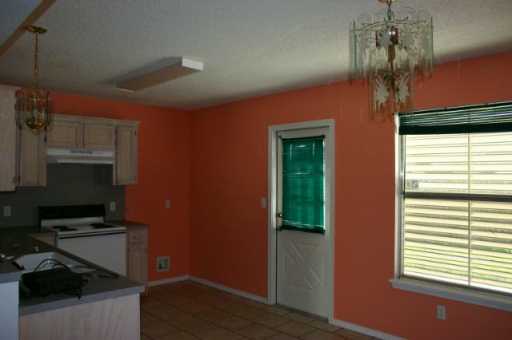 7813 Falcon Drive Corpus Christi, TX 78414 - Photo 3 of 6 a kitchen with stainless steel appliances a refrigerator and a stove