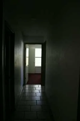 a hallway with a window in front of it