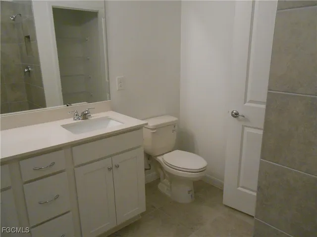 a bathroom with a sink toilet and vanity