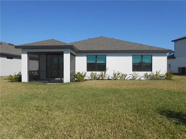 a front view of house with yard and trees