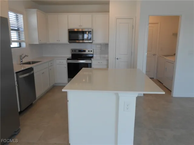 a kitchen with a sink a stove and refrigerator