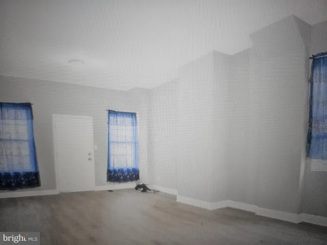 a view of a room with wooden floor and bathroom