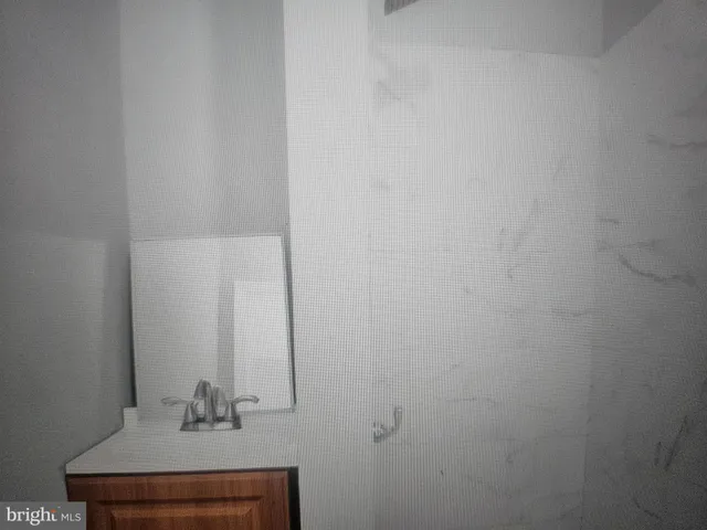 a kitchen with a stove and white cabinets