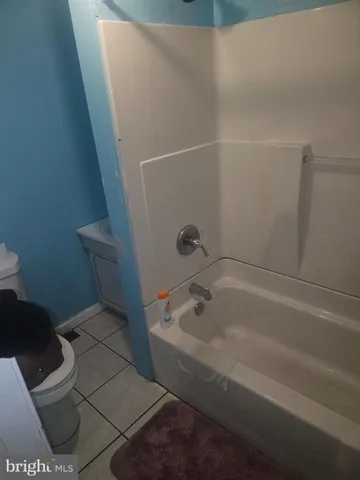 a bedroom with a bed and a tv