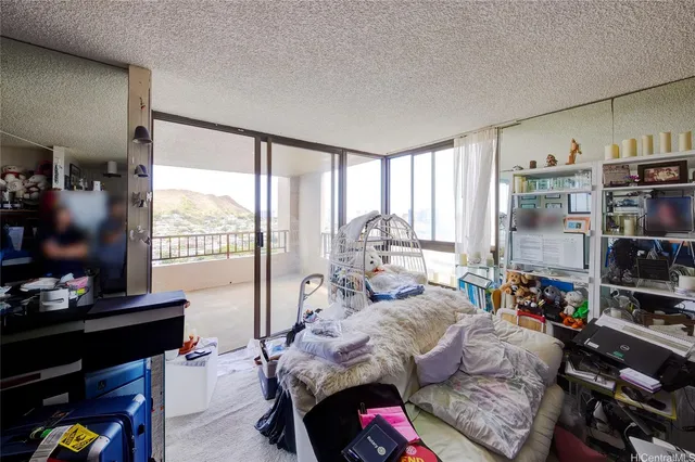 a bedroom with furniture and a flat screen tv