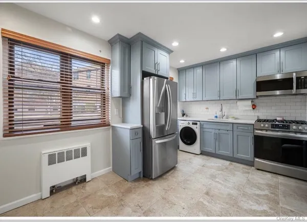 a kitchen with stainless steel appliances granite countertop a refrigerator and a stove top oven
