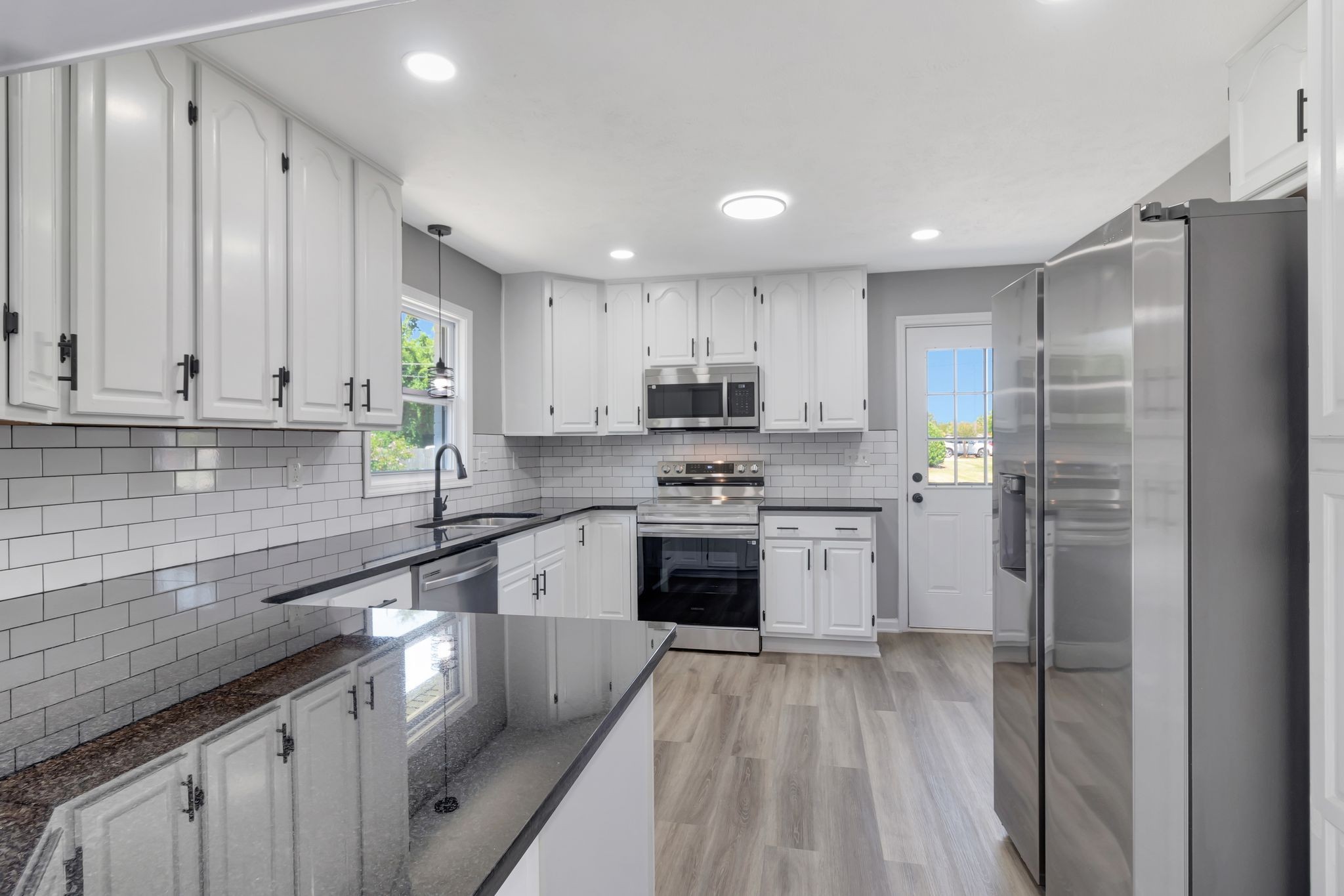 6799 Longview Drive Murfreesboro, TN 37129 - Photo 12 of 30 a kitchen with a refrigerator a sink and cabinets