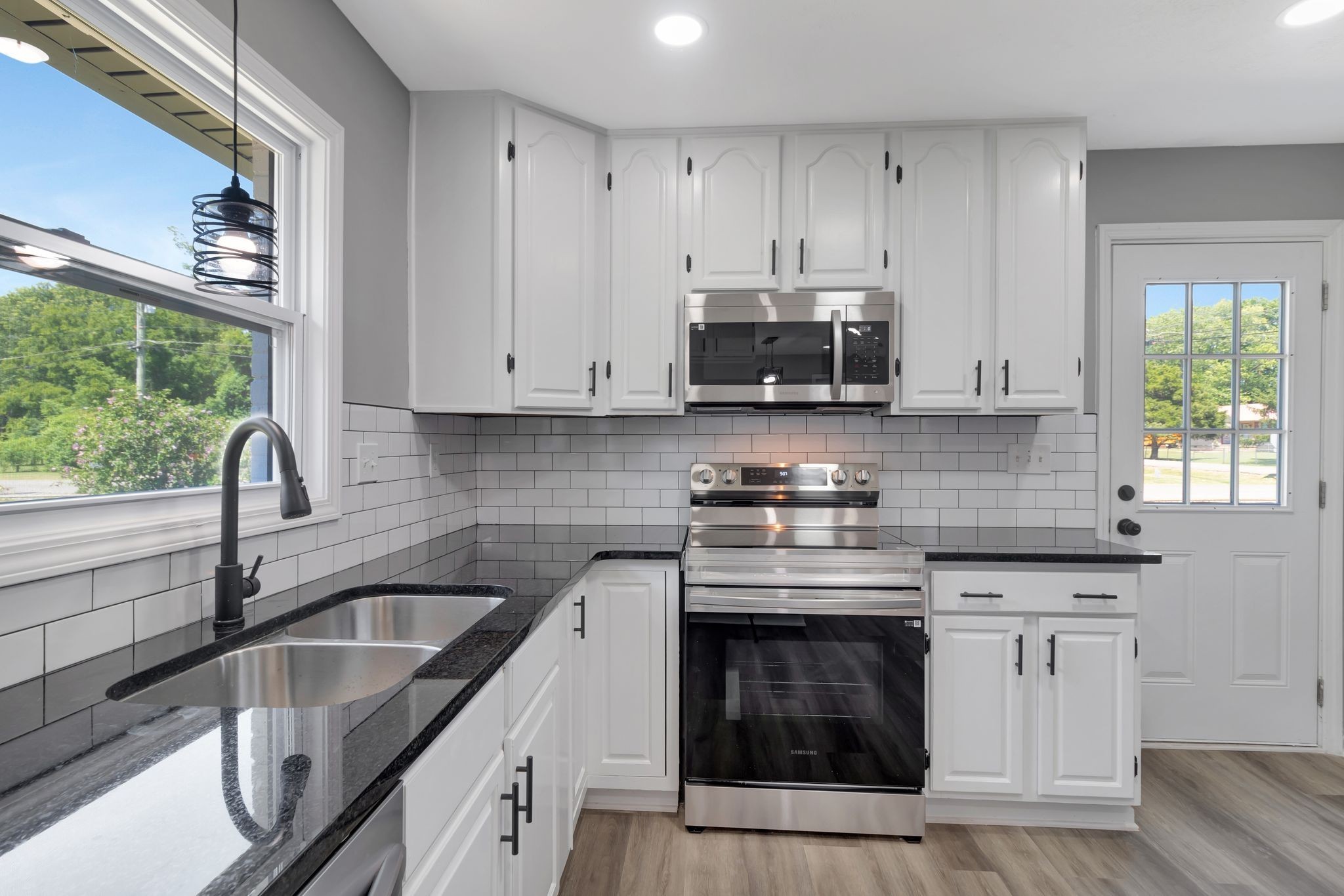 6799 Longview Drive Murfreesboro, TN 37129 - Photo 14 of 30 a kitchen with stainless steel appliances granite countertop a sink a stove and a microwave