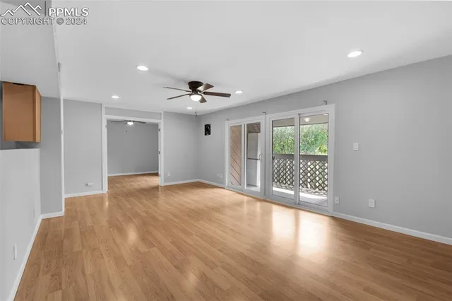 a view of an empty room and wooden floor
