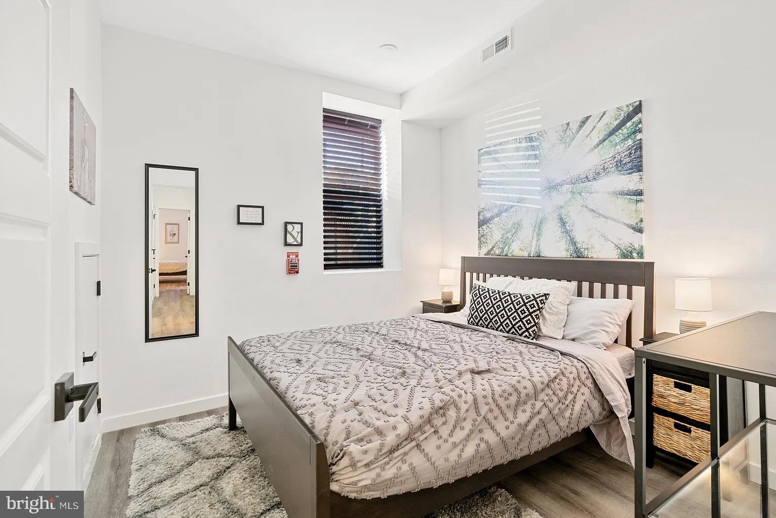 1735 South 23rd Street, Unit 2 Philadelphia, PA 19145 - Photo 11 of 17 a bedroom with a bed and a painting on the wall