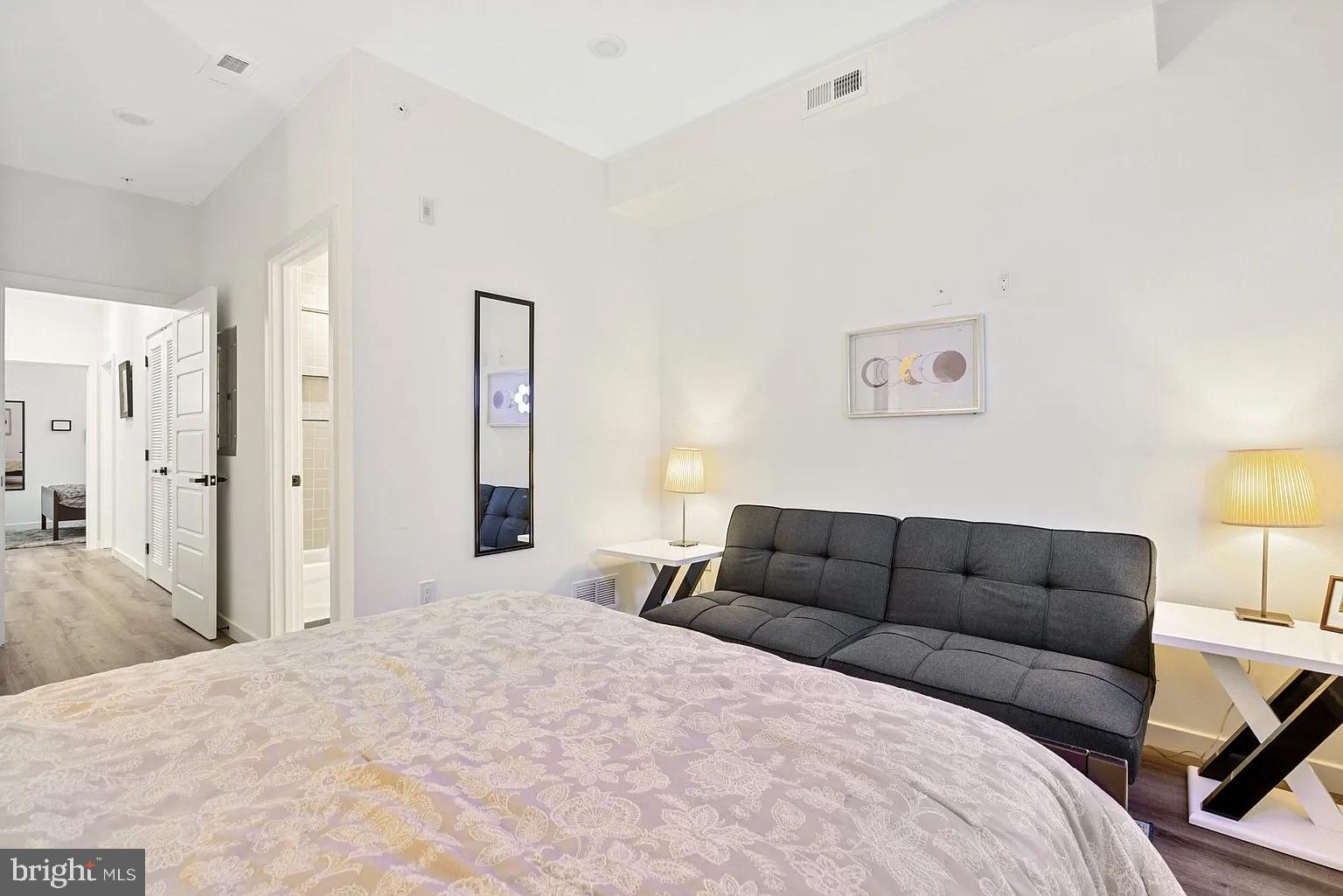 1735 South 23rd Street, Unit 2 Philadelphia, PA 19145 - Photo 12 of 17 a bedroom with a bed and a couch