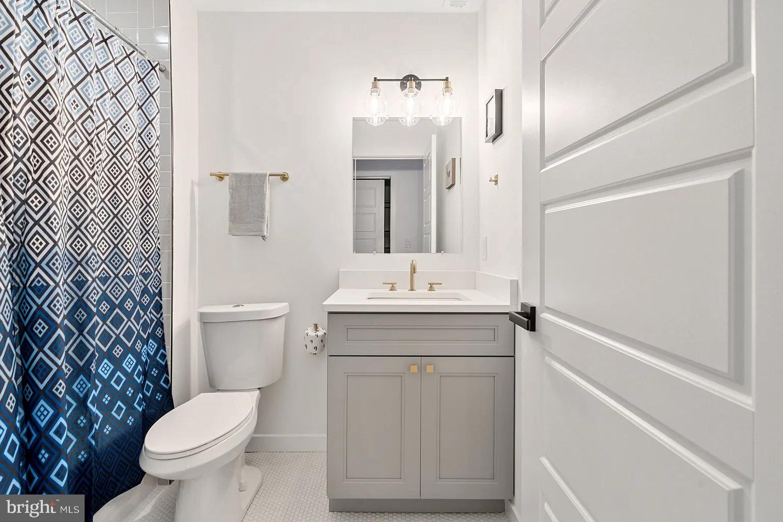 1735 South 23rd Street, Unit 2 Philadelphia, PA 19145 - Photo 14 of 17 a bathroom with a sink toilet and shower