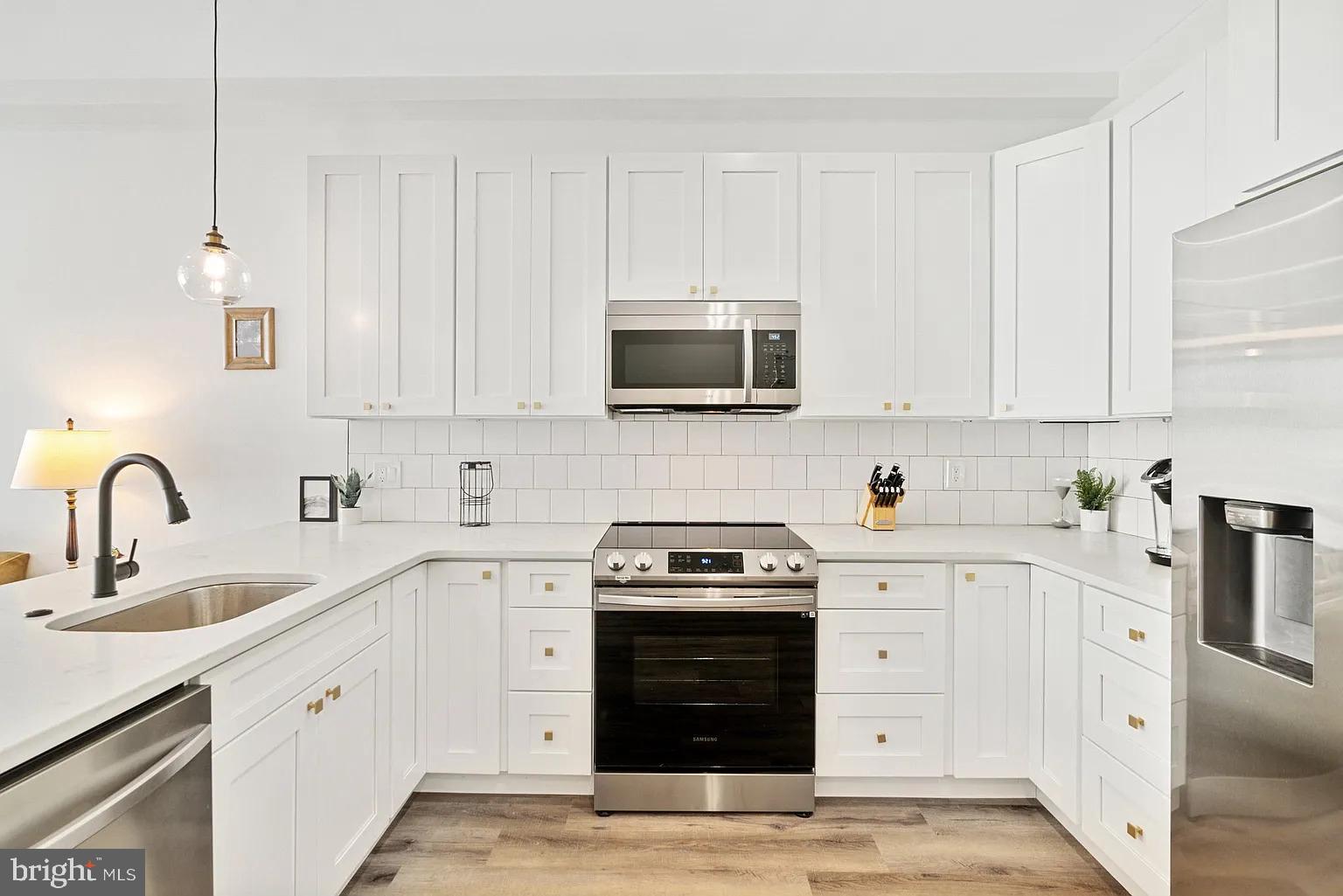 1735 South 23rd Street, Unit 2 Philadelphia, PA 19145 - Photo 3 of 17 a kitchen with stainless steel appliances granite countertop a stove a sink and white cabinets
