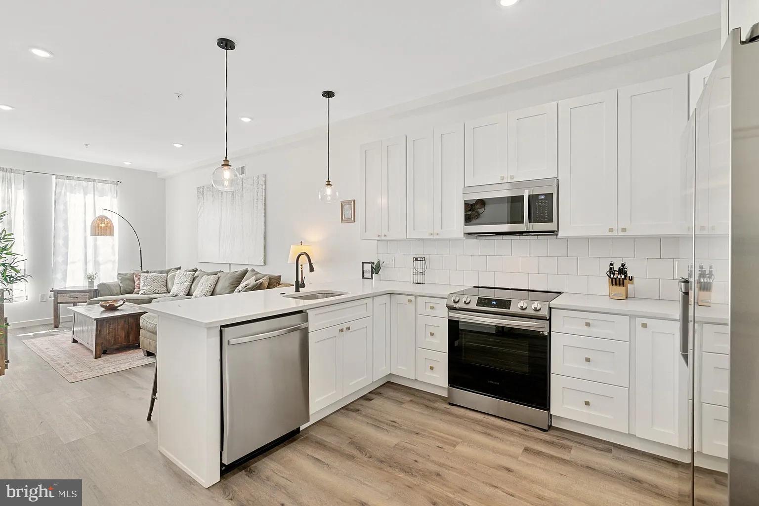 1735 South 23rd Street, Unit 2 Philadelphia, PA 19145 - Photo 6 of 17 a kitchen with a sink stove and white cabinets