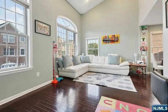 a living room with furniture wooden floor and a large window